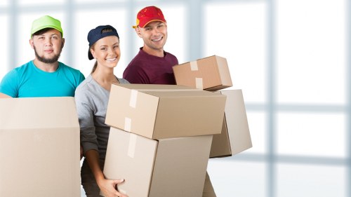 Removal crew moving furniture through a Croydon apartment building