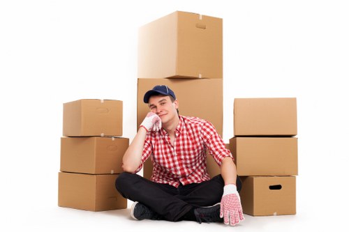 Staff wearing PPE while loading furniture into a removal van